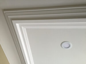 A white corner of a frame at the ceiling