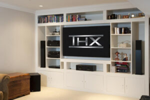 A living room area with shelves around the TV